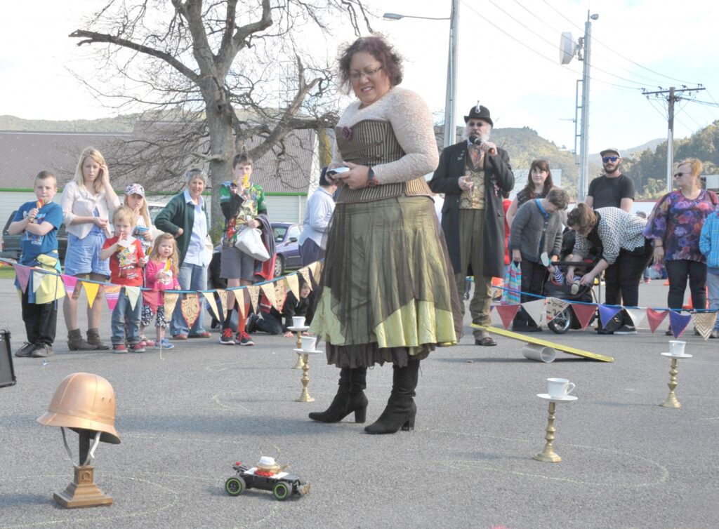 Steampunk's Gaylene van Wijk negotiates her remote controlled teapot around the obstacle course while MC ‘Colonel Hawthorne’ (aka Leslie Craven) keeps the crowd informed. PHOTO/CHRIS KILFORD