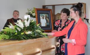 Paul’s wife Wendy and daughter Lauren place Paul’s photo at the ceremony yesterday. PHOTOS/SUPPLIED