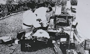 Vivian Spencer and John Ensor, who both worked for the New Zealand Broadcasting Service, setting up gear to record a ceremony at Bourail Cemetery. The pair were killed in a car crash while travelling back to Noumea to broadcast the service. PHOTO/SUPPLIED