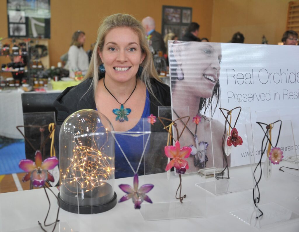 Brianna Billing (Kapiti Coast) with her orchids preserved in resin. PHOTO/CHRIS KILFORD