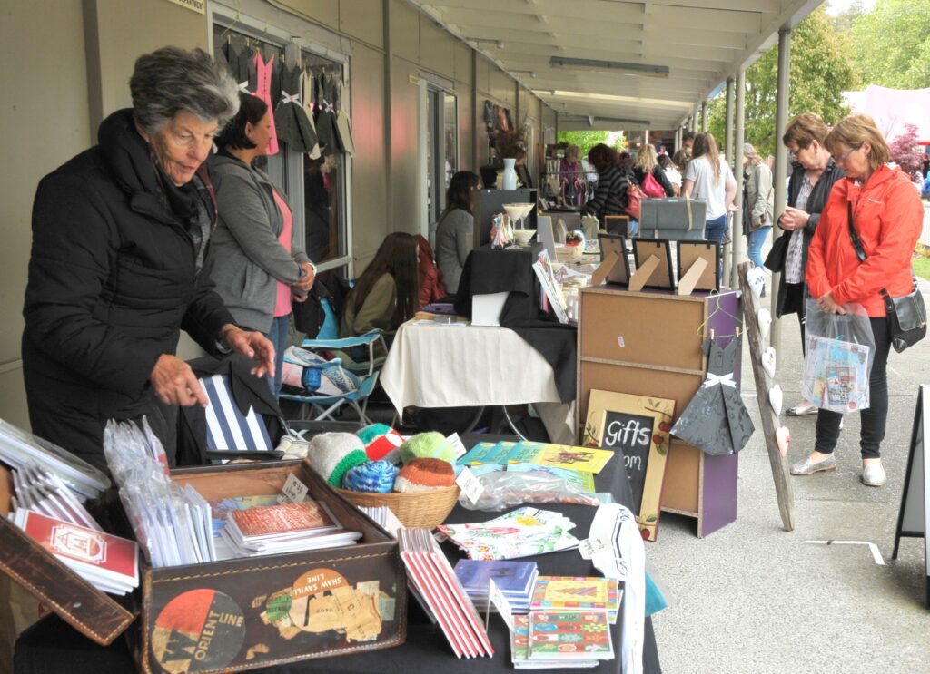 Stallholders set up under the verandahs to get out of the heavy drizzle. PHOTO/CHRIS KILFORD