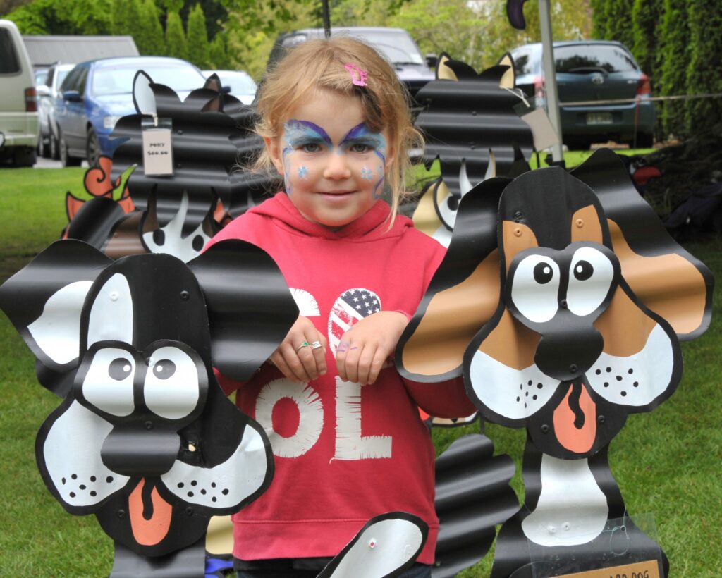 5 yr old Sophie Porten (Carterton) gets protection from the corrugated guard dogs. PHOTO/CHRIS KILFORD