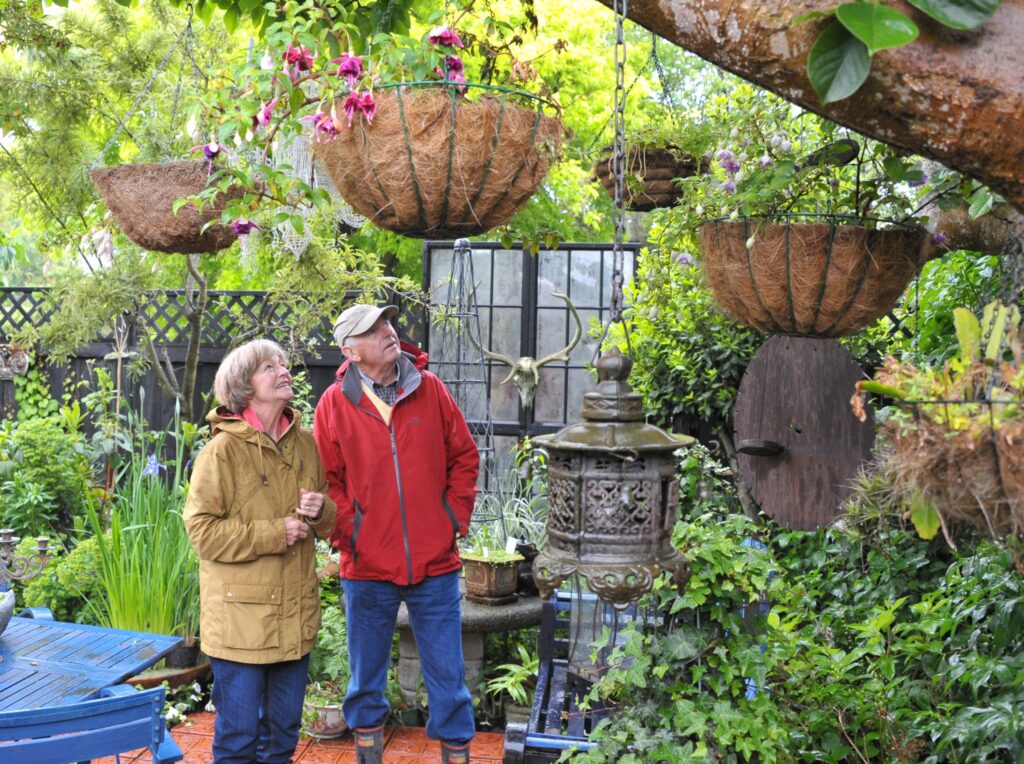 Wairarapa Garden Tour, Greytown, Saturday, Marilyn and John Errington (Martinborough) admire the hanging baskets. PHOTO/CHRIS KILFORD