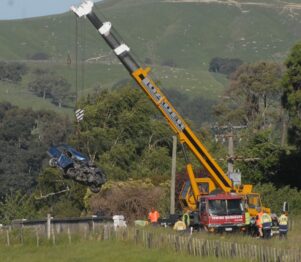The crushed vehicle is lifted from the Whangaehu River. PHOTO/BECKIE WILSON