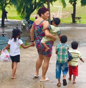 Ms Morris-Penfold with Cambodian children she helps support. PHOTO/SUPPLIED