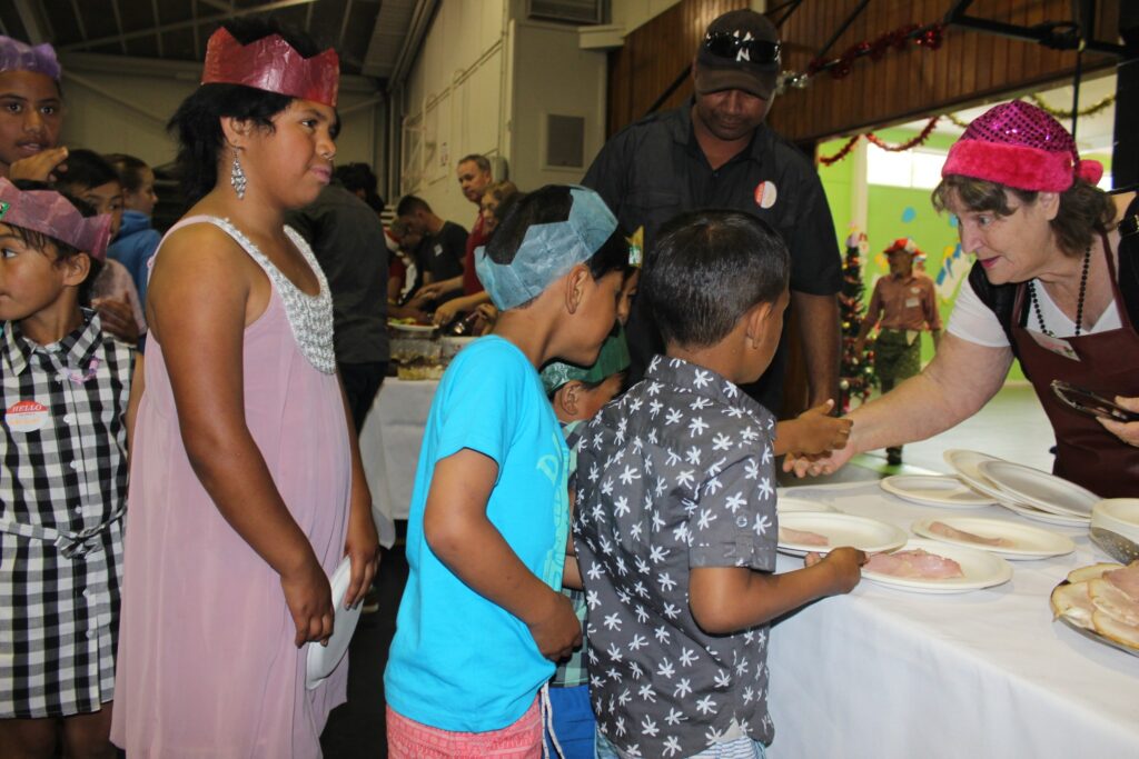 Children line up for a selection of Christmas meats. PHOTO/EMILY NORMAN