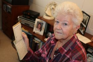 Ngaire Paterson, who joined the association in 1974, holding her husband’s account of the atomic bombing of Nagasaki. PHOTO/HAYLEY GASTMEIER