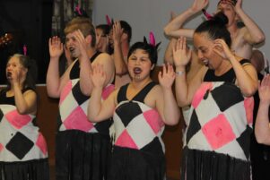 The girls looking pretty in pink as they sing for their families. PHOTO/EMILY NORMAN
