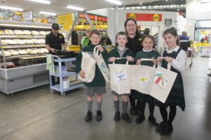 St Patrick’s pupils Benno Williams, left, Connor Kube, Awatea Ropiha-Waiwai, and Olivia Murray, with PAK’nSAVE’s ‘Café Queen’ Kataraina Paewhenua. PHOTO/EMILY NORMAN