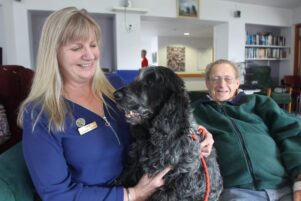 Diversional therapist Faye Leveridge, her dog Dougal, and Carter Court resident Bill Cardno. PHOTO/EMILY NORMAN