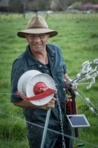 Ron Mark putting up a hot wire on Belvedere Rd. PHOTO/JADE CVETKOV
