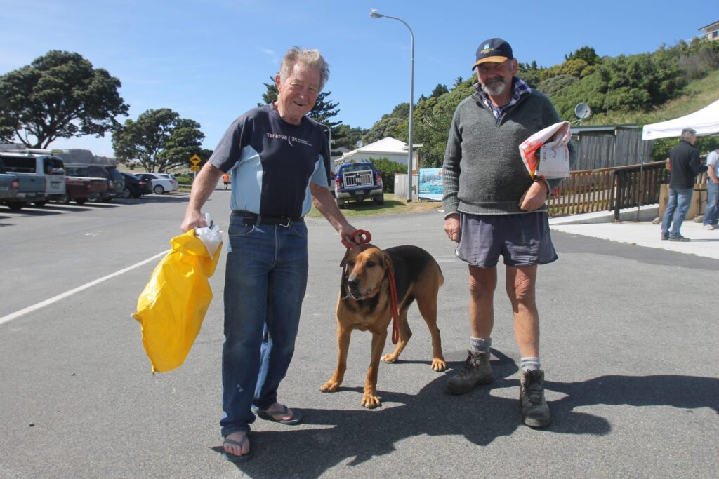Masterton District Councillor Chris Peterson with his huntaway Lad, and Pahiatua resident Alex Sheridan who came down for the clean-up. PHOTO/EMILY NORMAN