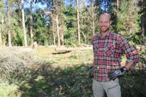 Tomas De Gooijer, from the Netherlands, clearing trees to make way for a new vegetable garden at the eco farm in Tauherenikau.