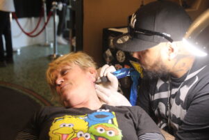 Donna Harper gets a semi-colon tattoo from artist Jordon Rimene. Donna lost her son Ryan to suicide in July. PHOTO/EMILY IRELAND